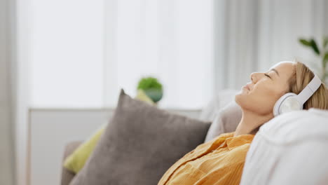 Headphones,-woman-on-couch-and-relax-on-break