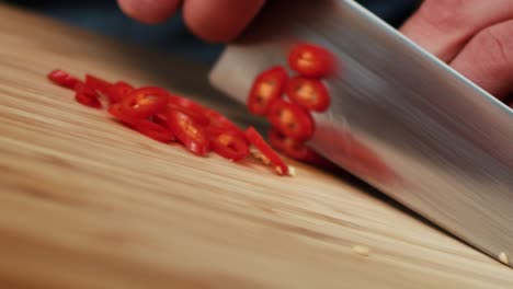 Tracking-video-of-slicing-chili-pepper-in-the-kitchen