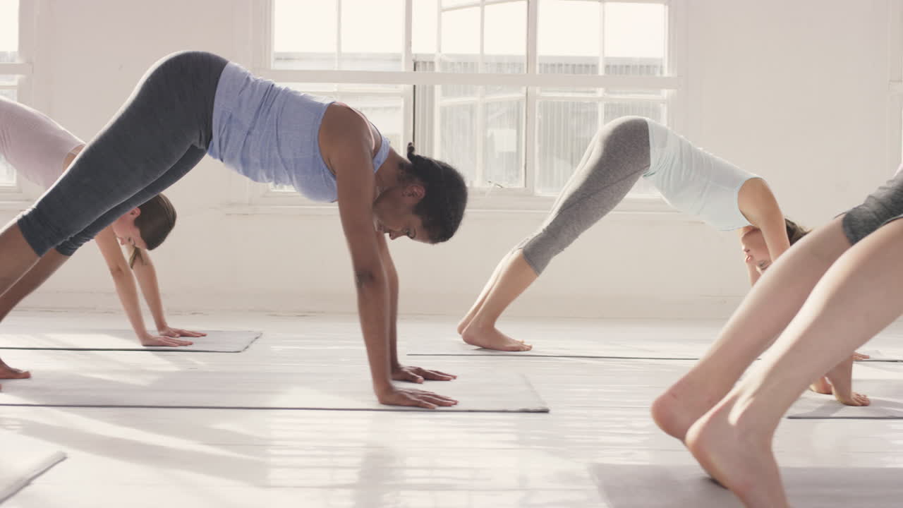 Yoga class multi racial group of women exercising fitness healthy lifestyle