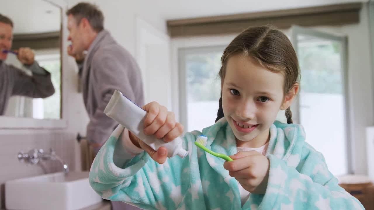 Happy girl pasting toothpaste on toothbrush 4k