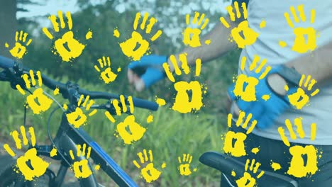 Animation-of-handprints-over-caucasian-man-cycling