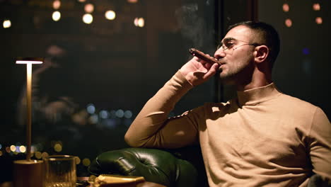 man smoking cigar in a night club