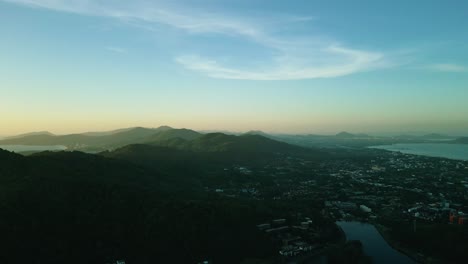 4k cinematic nature aerial footage of a drone flying over the beautiful beaches of promthep cape in phuket, thailand during sunset
