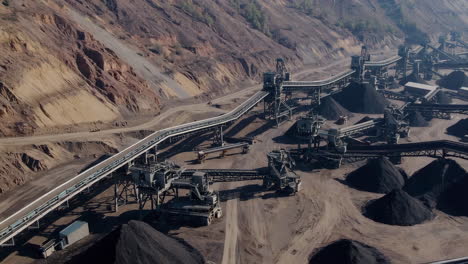 aerial view of a large open-pit mine with extensive conveyor belt systems