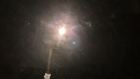 la lluvia golpeó el cristal de un coche en la noche oscura con una luz de carretera en la residencia familiar de nueva zelanda