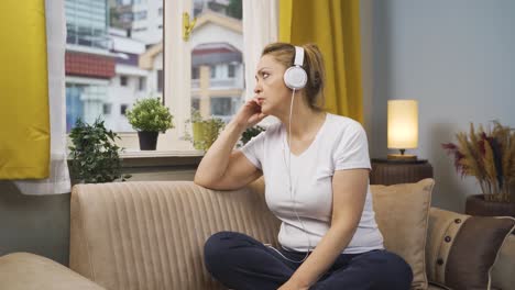 unhappy woman listening to music with headphones.