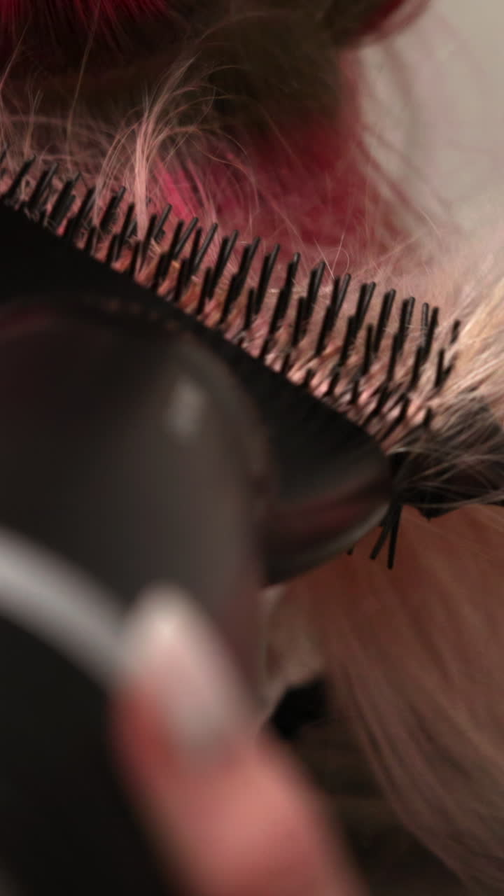 Close-up of Pink and Blonde Hair Being Styled with a Hot Air Brush