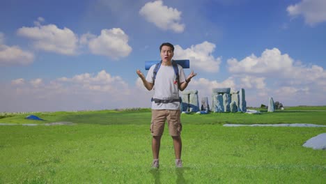 Full Body Of Puzzled Asian Male Hiker With Mountaineering Backpack Making Gestures Doubtfully And Saying Why While Traveling In Stonehenge