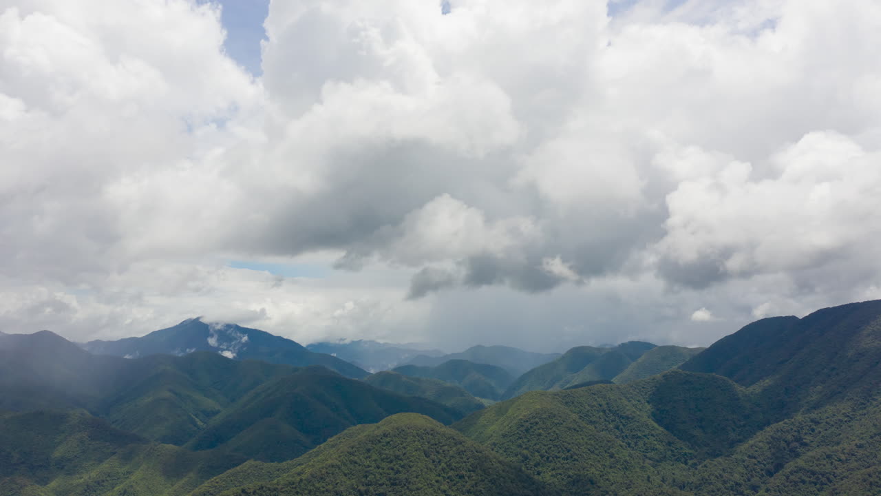 4K Time lapse of mountains on rainy day and clouds moving along the rain, stormy cloud, rainy season forest landscape background