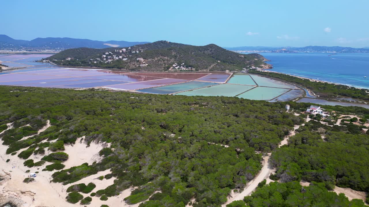 colorful salt flats of Ibiza with the Mediterranean vegetation in the foreground. Gorgeous aerial view flight drone shot footage from above