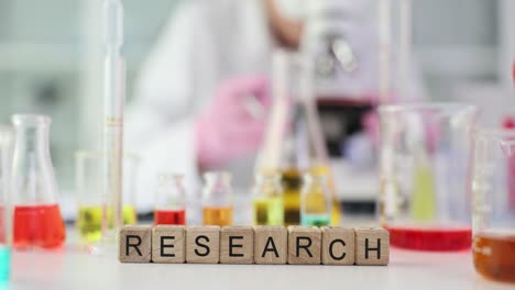 research lab setup with chemical glassware and 'research' blocks