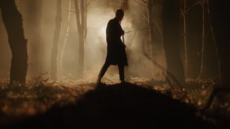 man working in the foggy forest at night