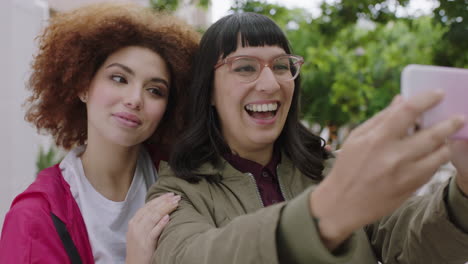 portrait of young beautiful women friends posing taking selfie using smartphone enjoying friendship girlfriends enjoying hang out in city