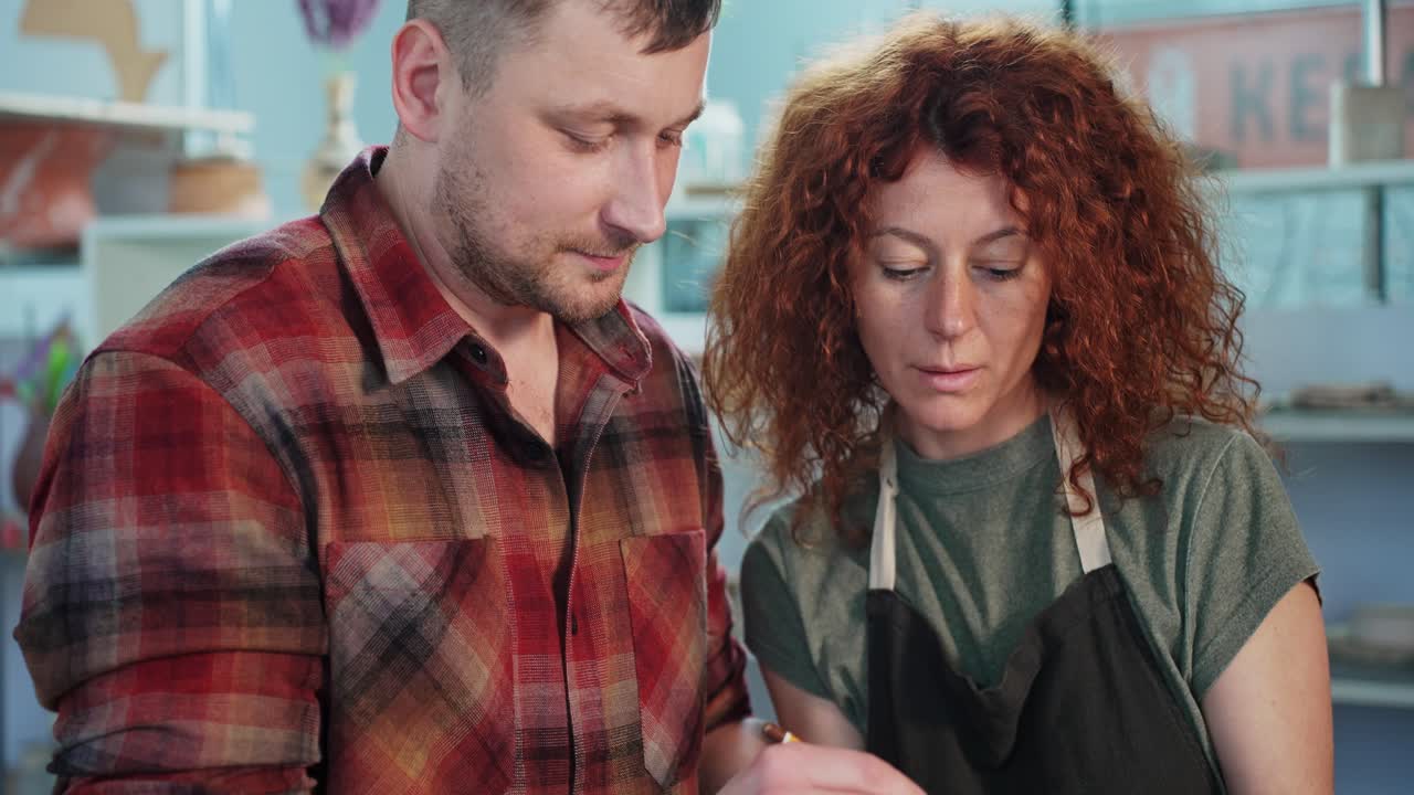 Couple collaborating on a pottery design