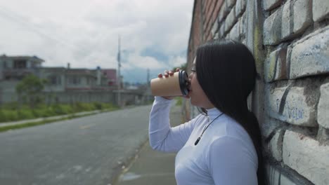 young hispanic woman with straight black hair and a white long sleeve shirt