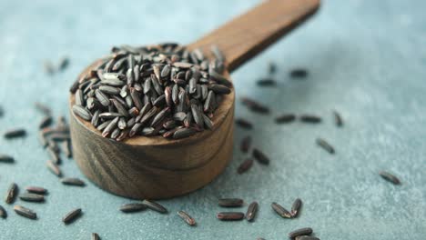 black rice in wooden spoon