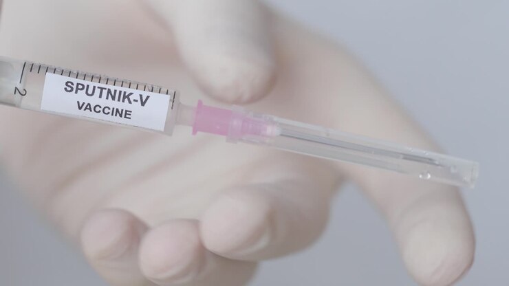 Hand Pull Out The Needle From Syringe With Sputnik-V Vaccine , Close Up Shot