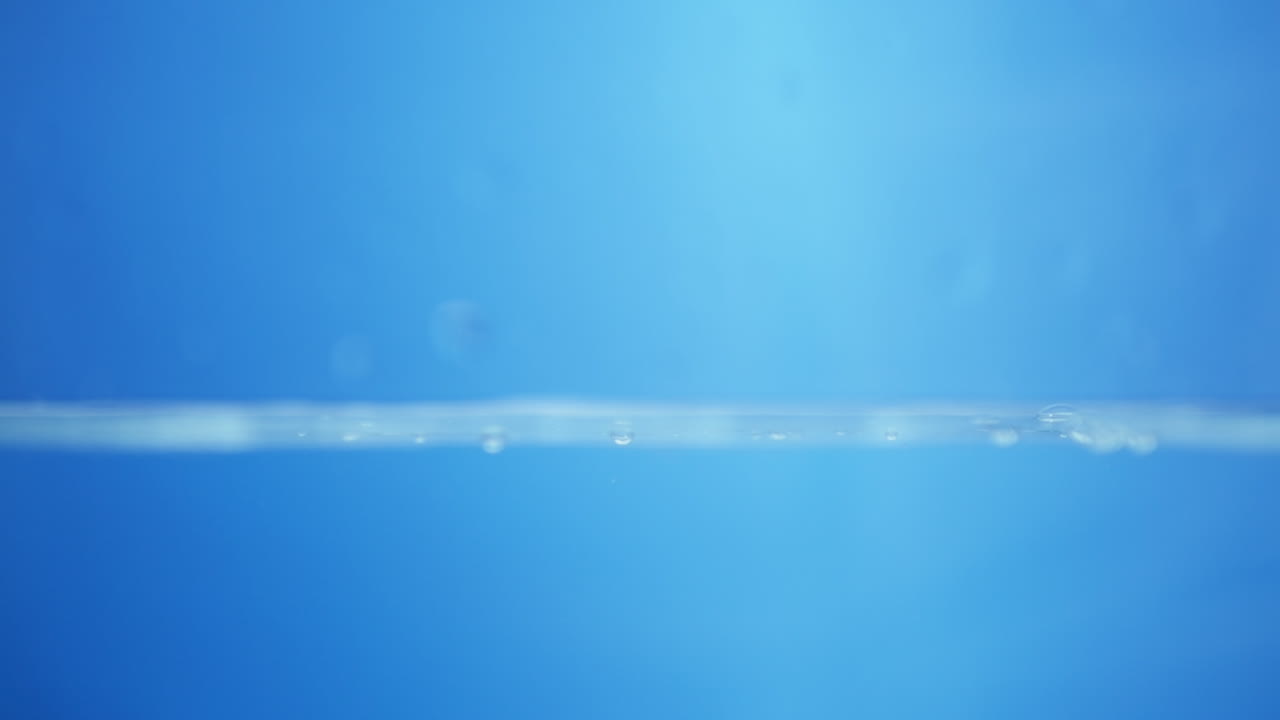 Charming visuals of water's surface, showcasing the soothing qualities and purity of clean drinking water in slow motion.