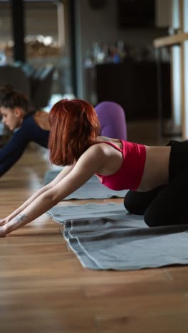 women practicing yoga in a studio