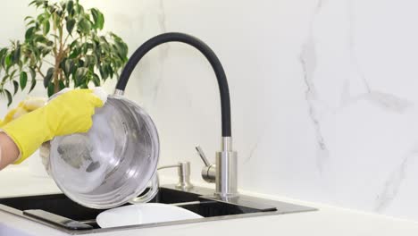 person washing dishes in a modern kitchen