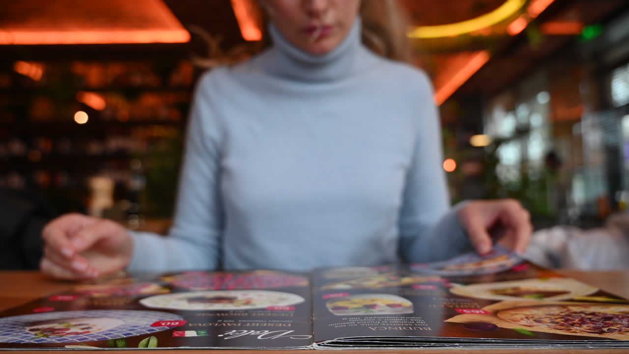 Woman reading a menu at a restaurant at business lunch