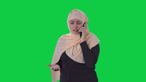 Angry-Muslim-woman-talking-on-phone-Green-screen