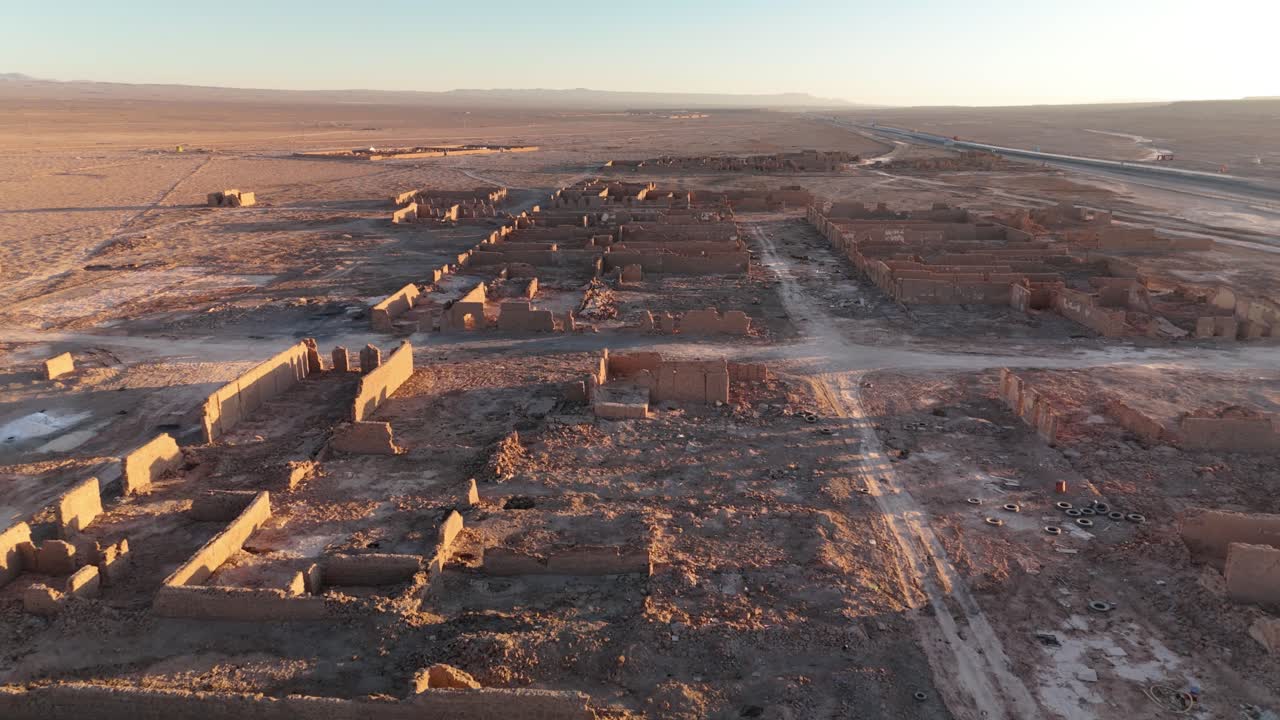 Drone flyover over an abandoned former saltpeter mine at sunset in the desert