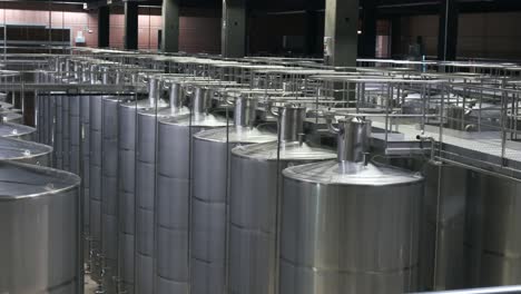 modern winery with stainless steel fermentation tanks in high-tech winemaking facility