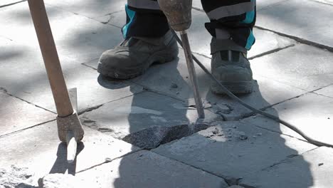 breaking up paving stone with jackhammer