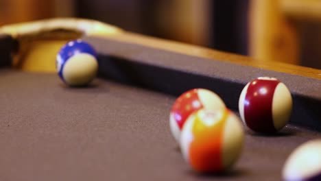 rolling colored balls trying to score at billiard