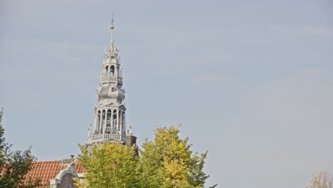 tilt down from the old church tower in amsterdam towards a beautiful canal