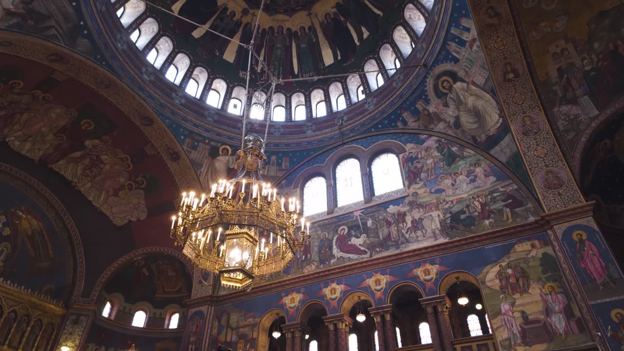 Ornate sacred artwork, featuring detailed frescoes and traditional religious paintings within Sibiu’s historic cathedral