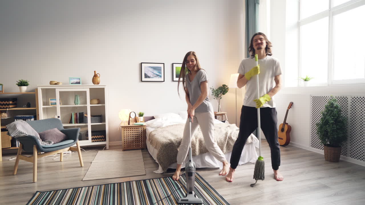 Couple Cleaning and Dancing