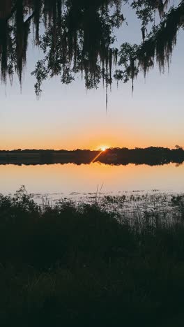 sunrise or sunset over a calm lake