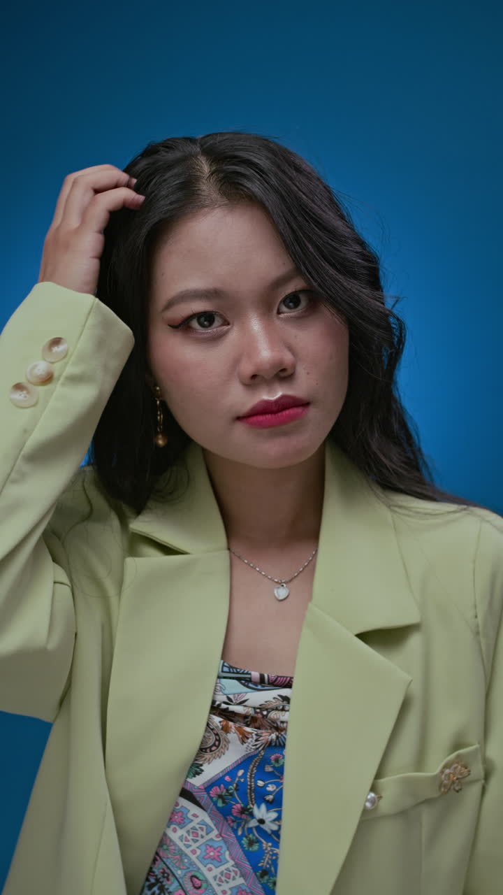 Asian Brunette Expressing Surprise on Neon Blue Background