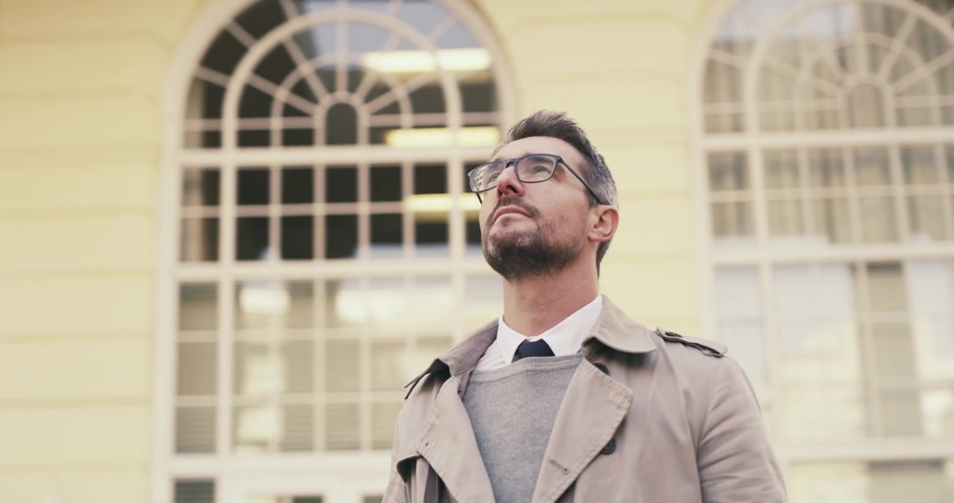 Man Looking Up at Building