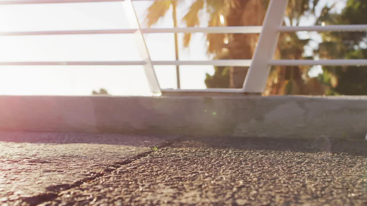 Runner stepping onto sunny bridge, shoe contact causing teal UI markers tracking stride for fitness