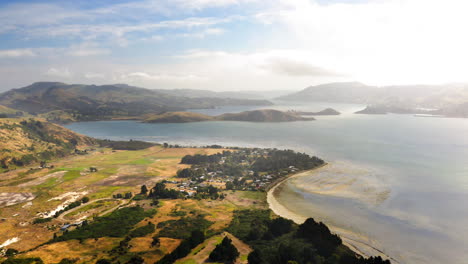 aerial view of a scenic coastal landscape with a bay and small settlement