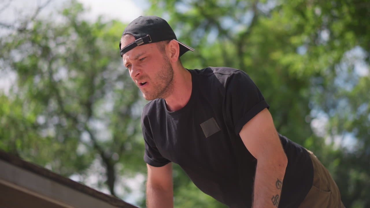 Man Doing Pushup, Strenuous Workout Captured From Below, Physical Exertion On Park Bench In Gritty City Setting, Man Performs Intense Pushup With Determination In Urban Park Environment