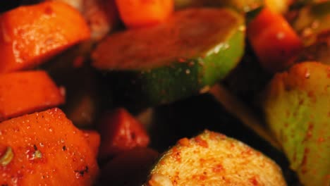 cinematic close-up pan of grilled vegetables including juicy red bell peppers, zucchini, carrots and cauliflower