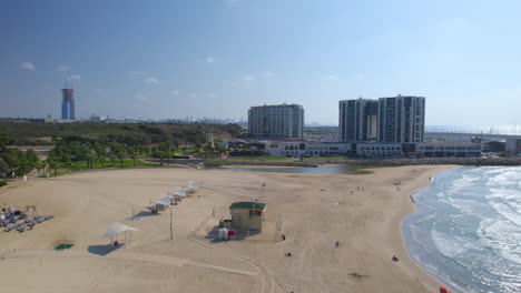 acadia south herzliya beach next to the marina is almost empty of people on a hot summer day