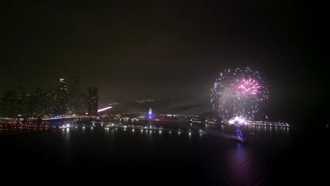 fireworks from a ship exploding in the air at night