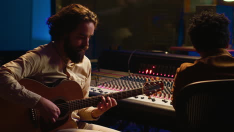 rockstar recording music on his guitar in professional studio