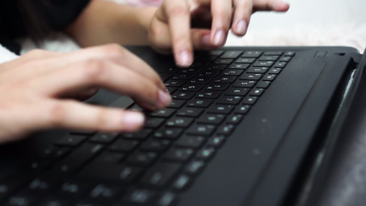 Girl's fingers type on a keyboard