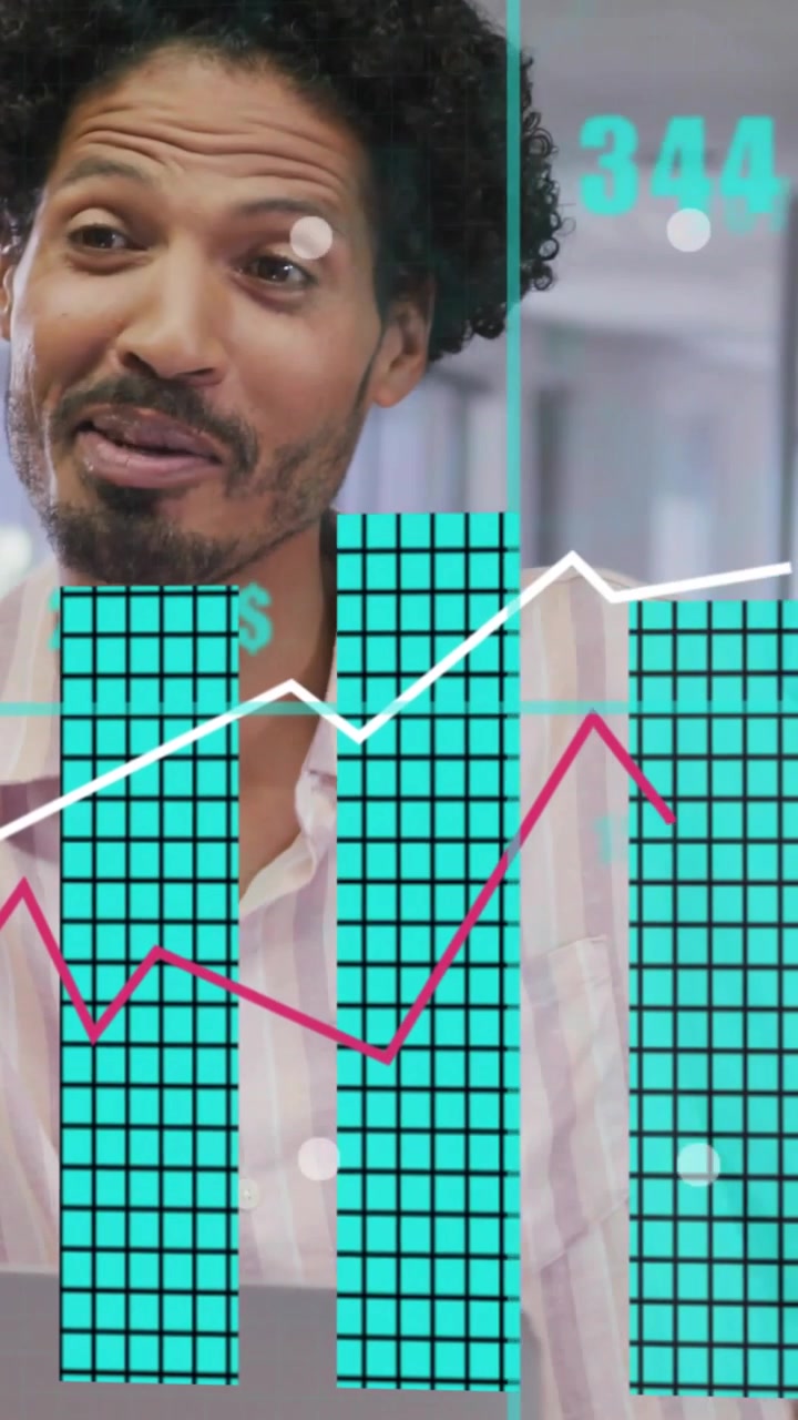 Vertical video: Smiling office man in pink-striped shirt reacting to numeric overlays and charts