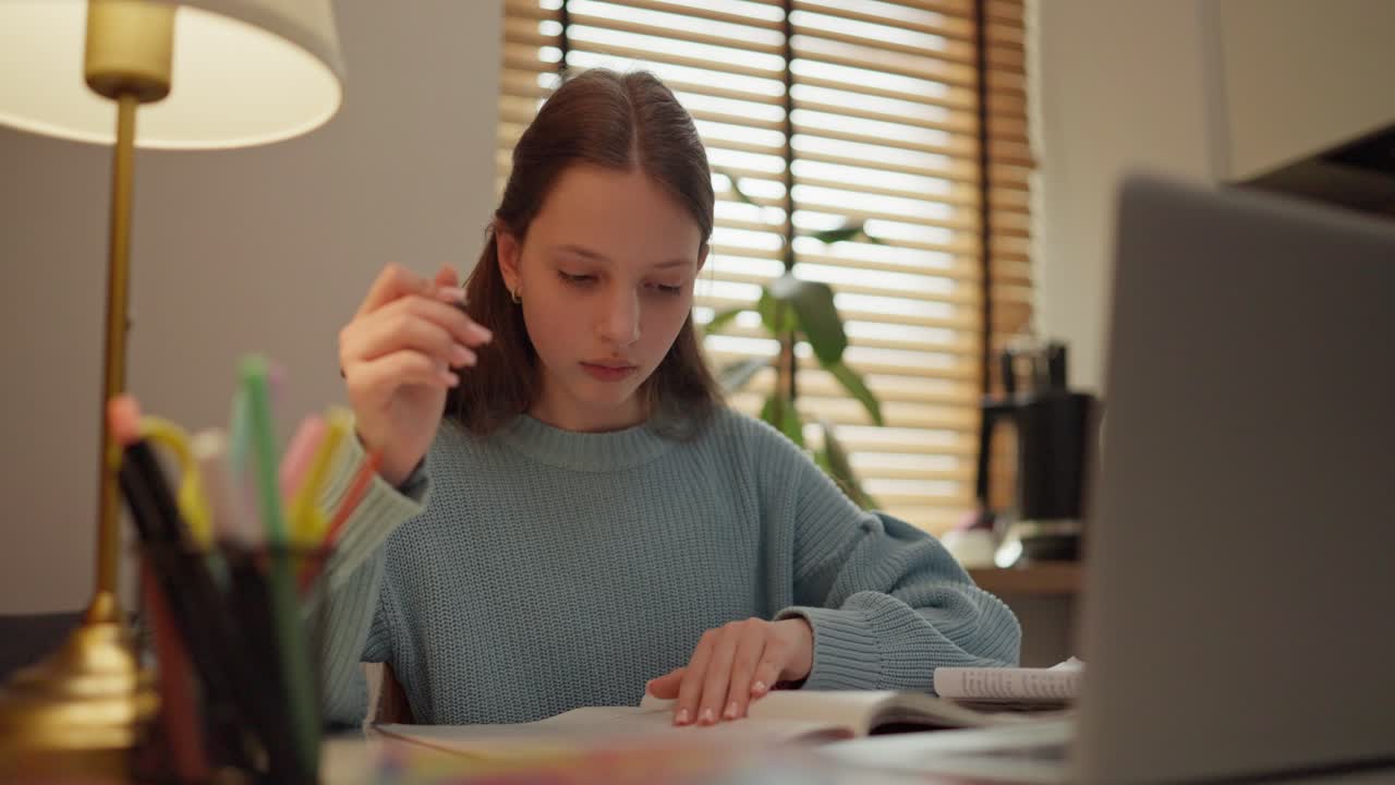 Girl studying at home with laptop
