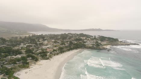 carmel-by-the-sea beach drone video foggy morning surfers on waves - sliding right