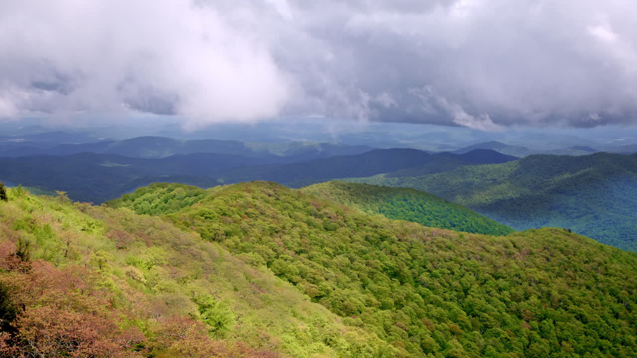 Drone glides over the vast Smoky Mountains as fog, mist, and rain create a moody atmosphere