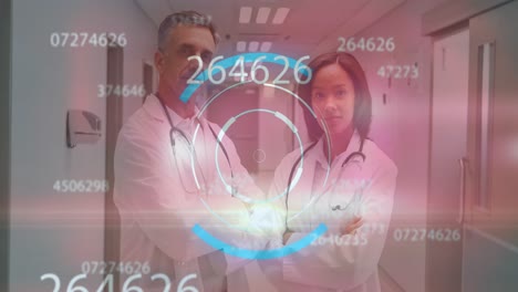 Animation-of-round-scanner-and-numbers-over-diverse-male-and-female-doctor-standing-at-hospital