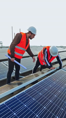 engineers checking solar panels. engineers working on checking and maintenance equipment at green energy solar power plant